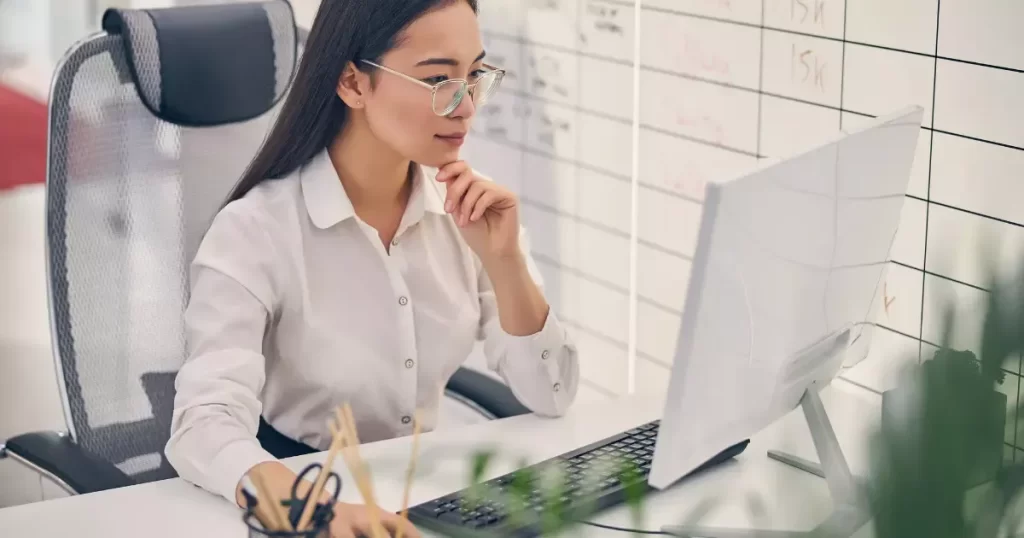 Woman doing SEO strategy research at computer