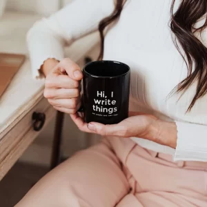 mugs for freelancers, woman holding cup reads I write things eat snacks and take naps