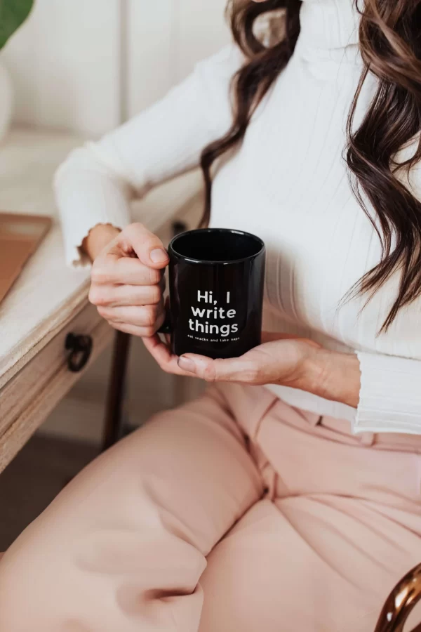mugs for freelancers, woman holding cup reads I write things eat snacks and take naps
